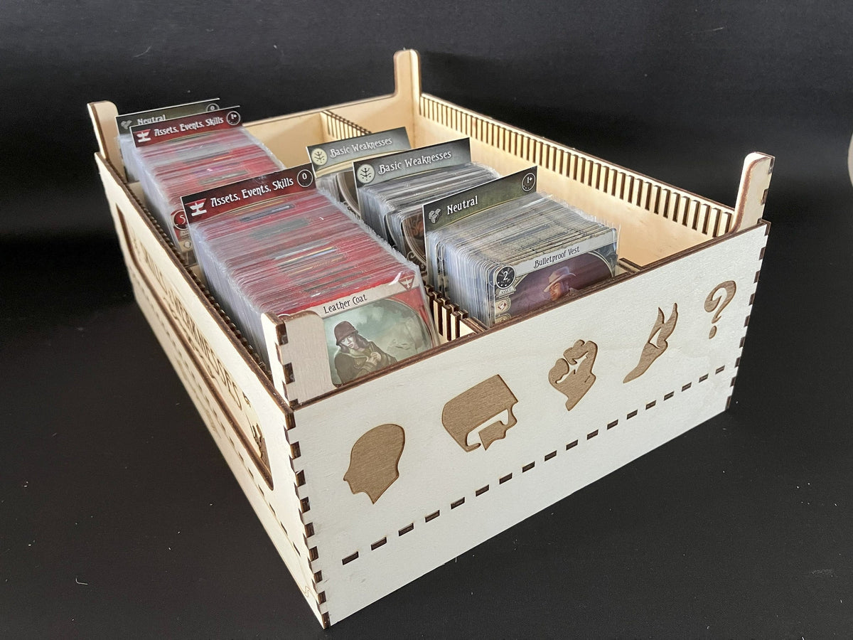 Natural wooden card storage tray filled with Arkham Horror cards in sections, side engraved with class icons