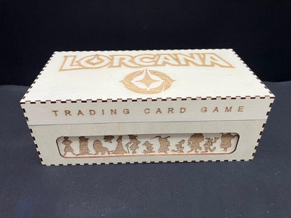Natural wooden box with Lorcana and Trading Card Game engraved on the lid and front, and a row of character silhouettes