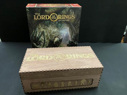 Engraved wooden double storage box with Lord of the Rings title on the lid, next to The Card Game box