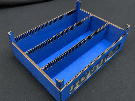 Blue wooden three-row card tray with slotted divider rails and engraved character silhouettes on the side