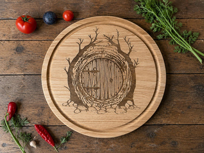 Round wooden chopping board engraved with a round hobbit door between twisting trees, with fresh vegetables