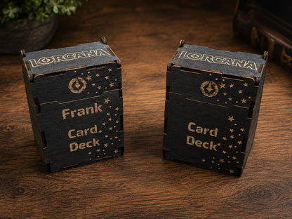 Two black wooden deck boxes engraved with the Lorcana logo, stars and Card Deck, one personalised with the name Frank