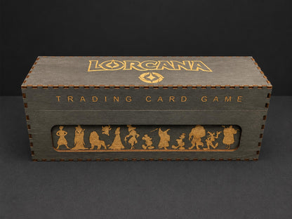 Grey wooden storage box engraved in gold with the Lorcana logo, Trading Card Game and a row of character silhouettes