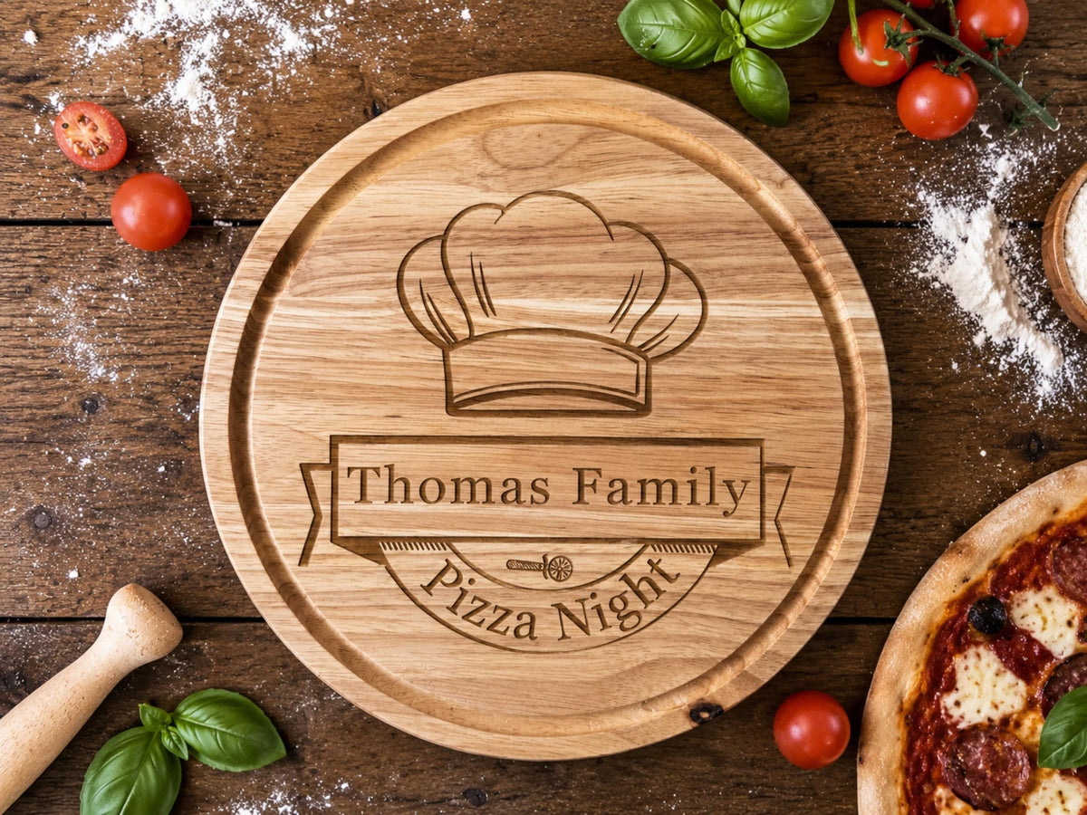 Round wooden board engraved with a chef's hat, Thomas Family banner and Pizza Night, beside a pizza