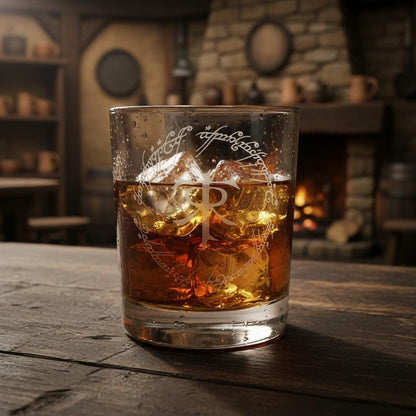 Whisky tumbler engraved with the Tolkien monogram in a ring of elvish script, filled with whisky and ice by a fire